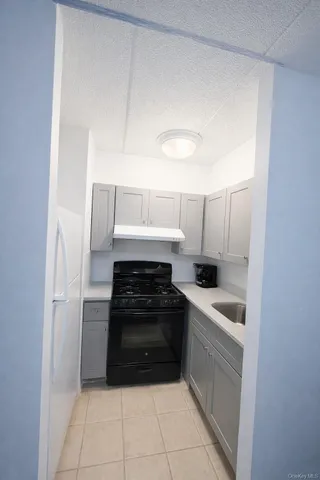 a kitchen with a sink and white cabinets
