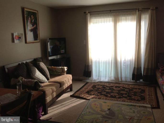 2917 Hickory Leaf Way Silver Spring, MD 20904 - Photo 7 of 8 a living room with furniture and a flat screen tv