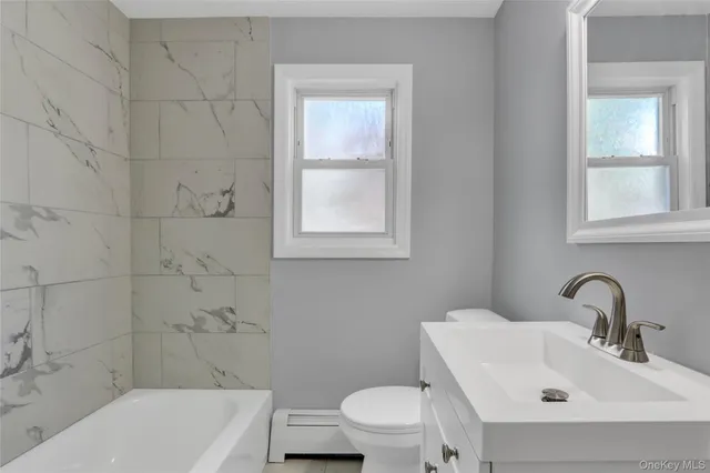 a bathroom with a sink toilet and bathtub