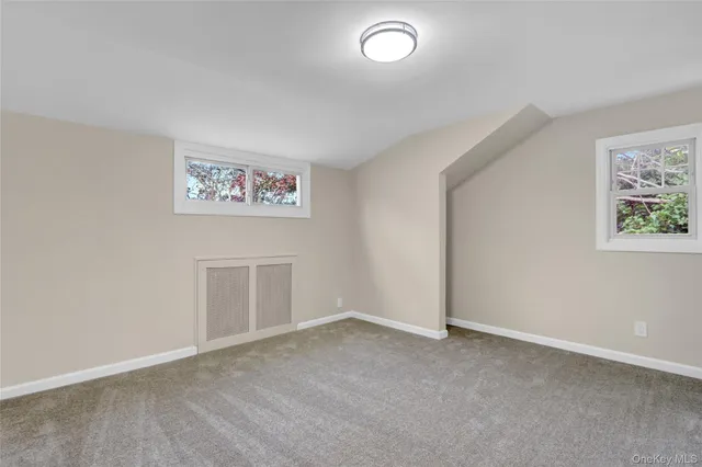 an empty room with a painting on the wall