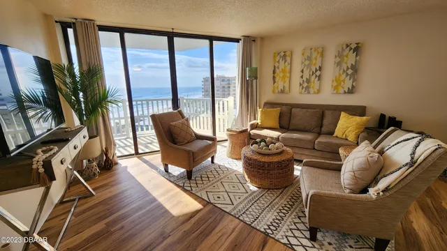 a living room with furniture and a floor to ceiling window