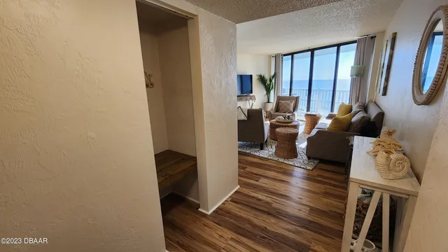 a living room with furniture a window and a flat screen tv