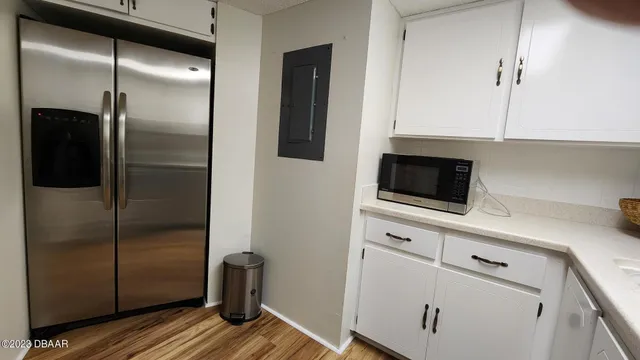 a kitchen with a refrigerator and a sink