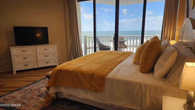 a bedroom with a bed and a flat screen tv