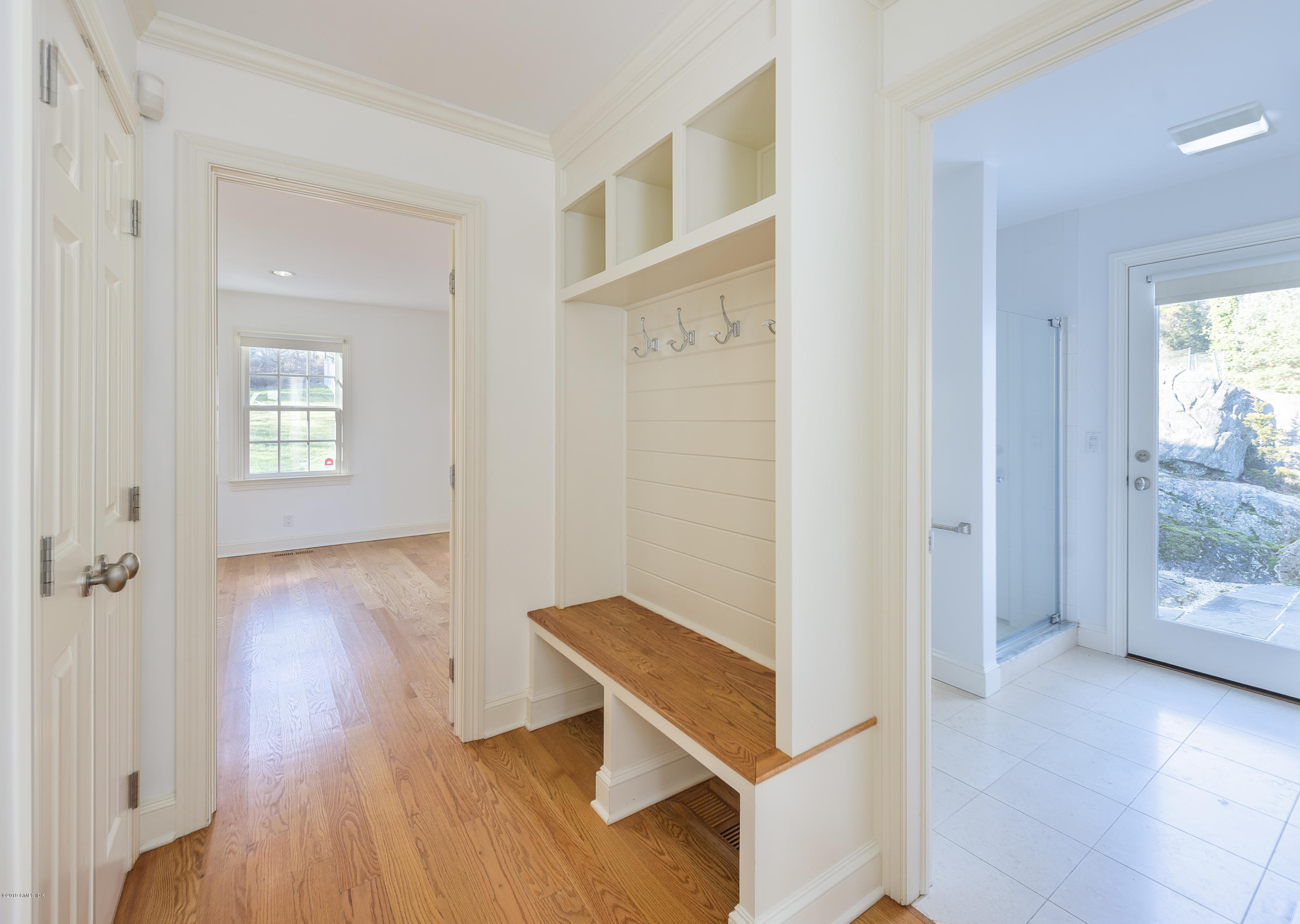 111 Dingletown Road Greenwich, CT 06830 - Photo 17 of 44 a view of a hallway with wooden floor and a bathroom