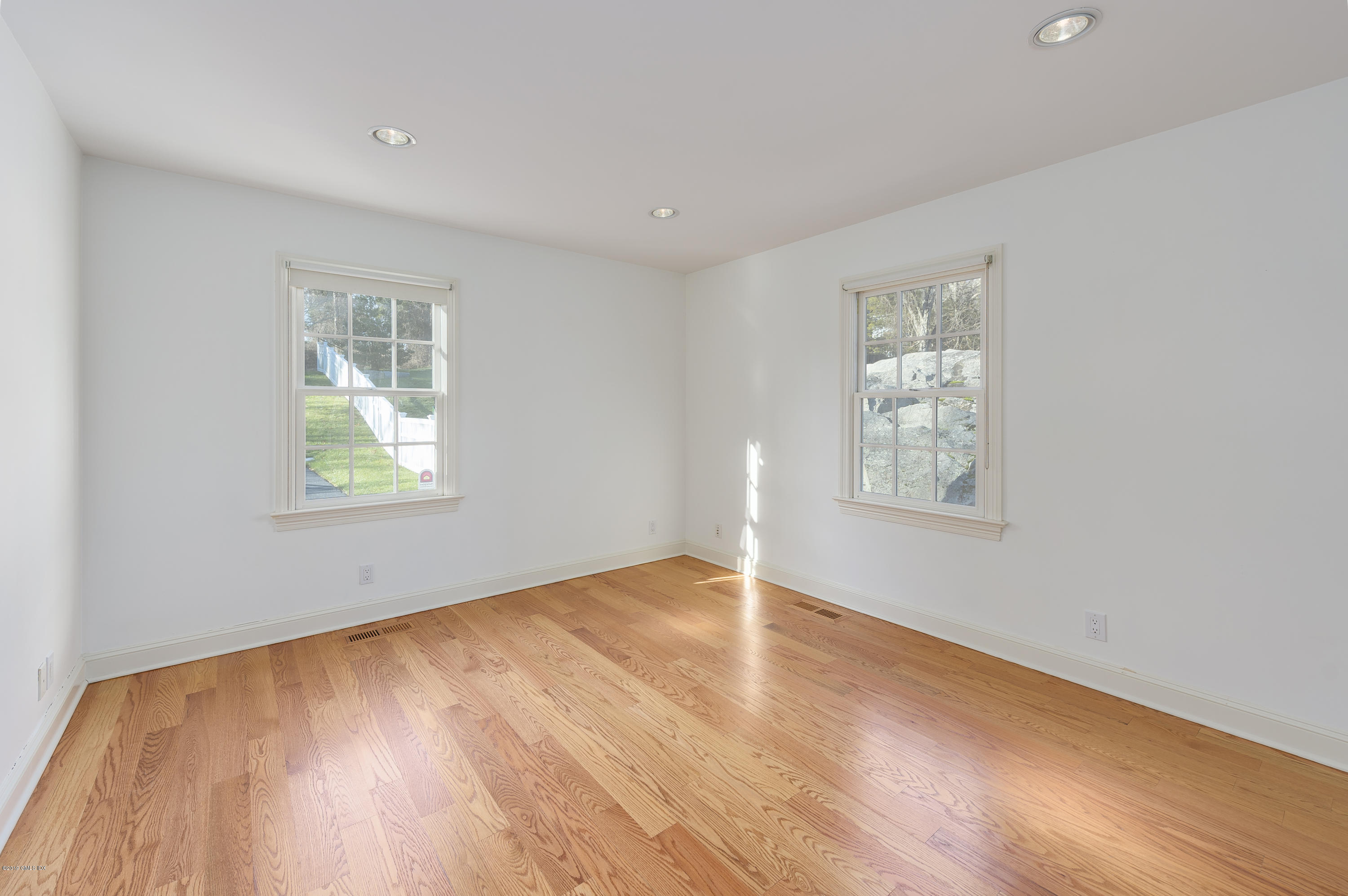 111 Dingletown Road Greenwich, CT 06830 - Photo 18 of 44 an empty room with wooden floor and windows