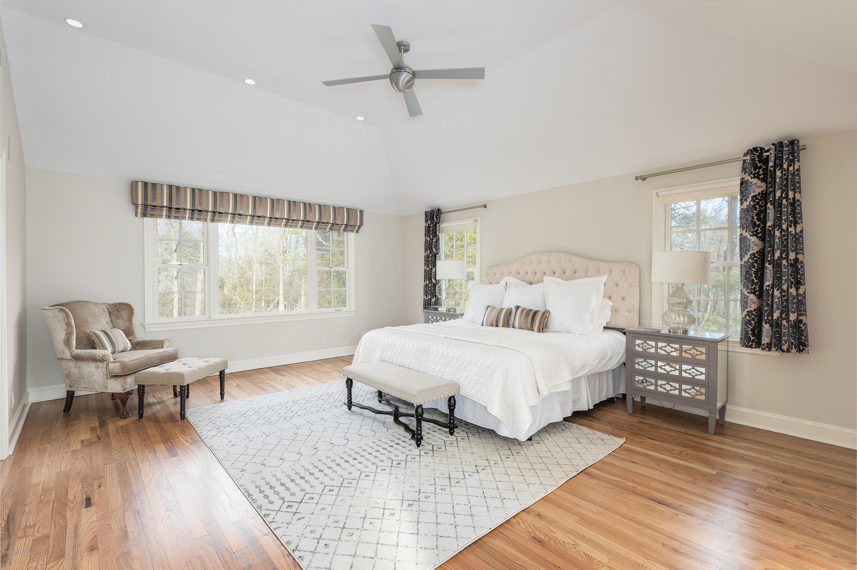 111 Dingletown Road Greenwich, CT 06830 - Photo 20 of 44 a bedroom with a bed and wooden floor
