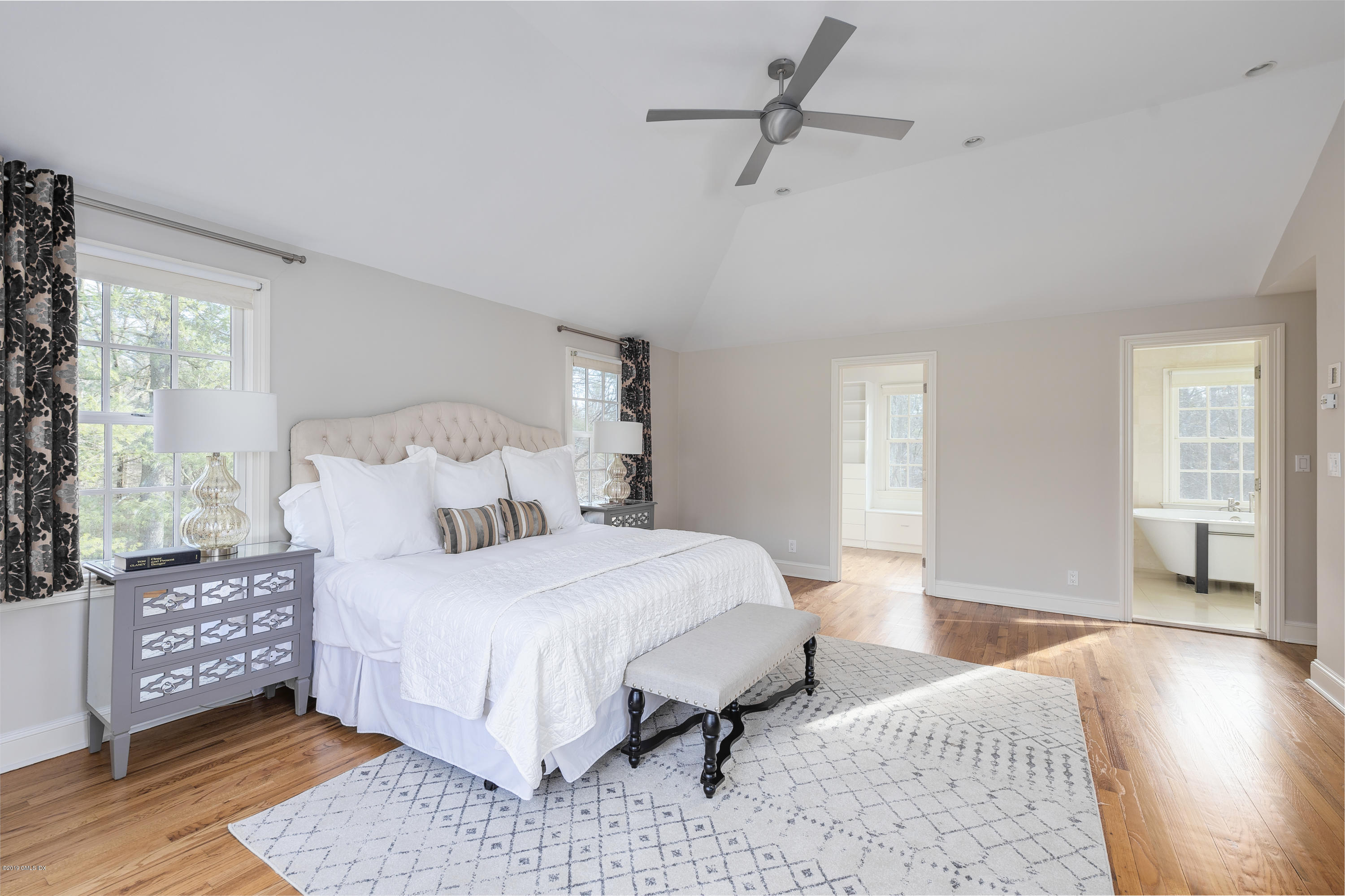 111 Dingletown Road Greenwich, CT 06830 - Photo 21 of 44 a bedroom with a bed rug and wooden floor