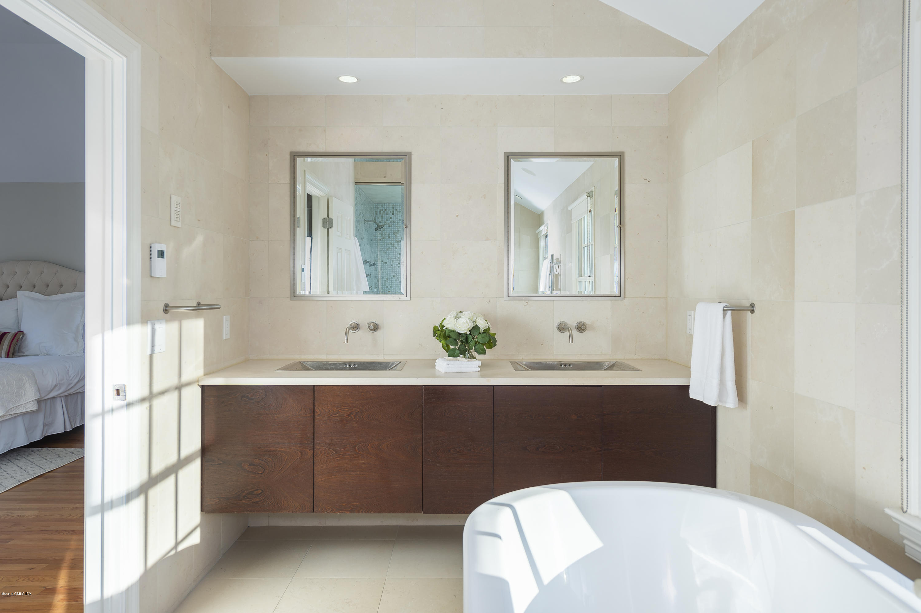 111 Dingletown Road Greenwich, CT 06830 - Photo 23 of 44 a spacious bathroom with a bathtub sink and mirror