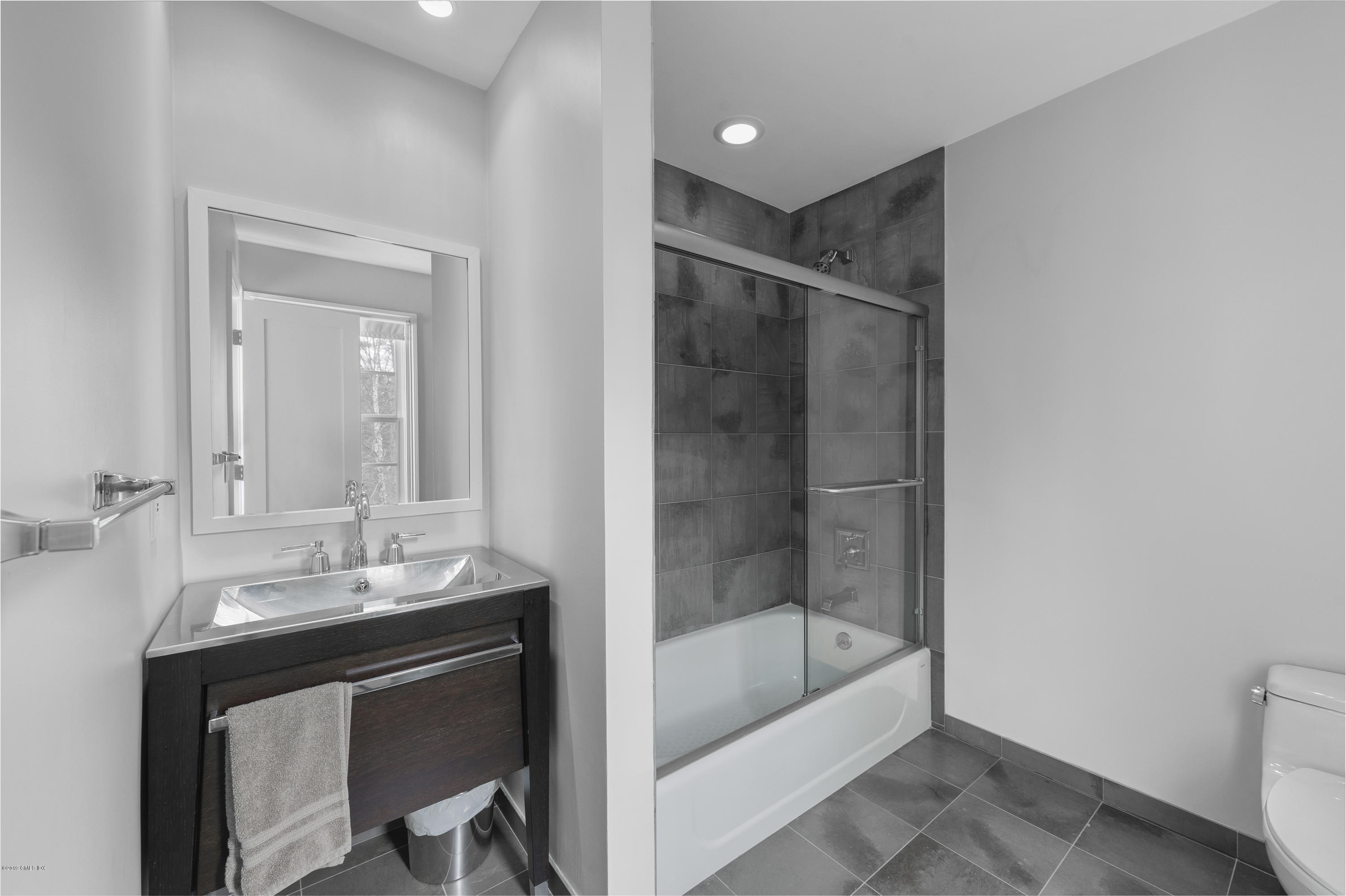 111 Dingletown Road Greenwich, CT 06830 - Photo 28 of 44 a bathroom with a shower sink and mirror