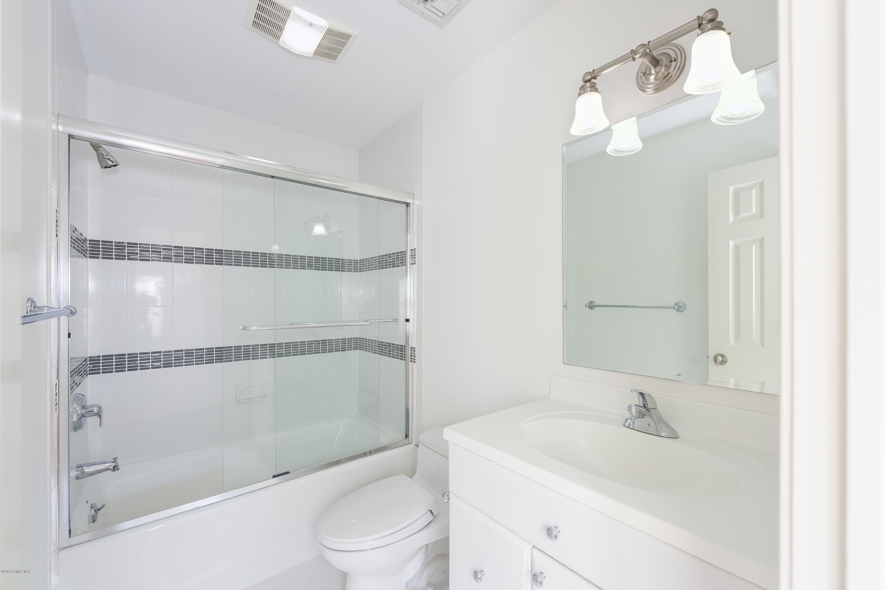111 Dingletown Road Greenwich, CT 06830 - Photo 30 of 44 a bathroom with a bathtub shower sink vanity and toilet