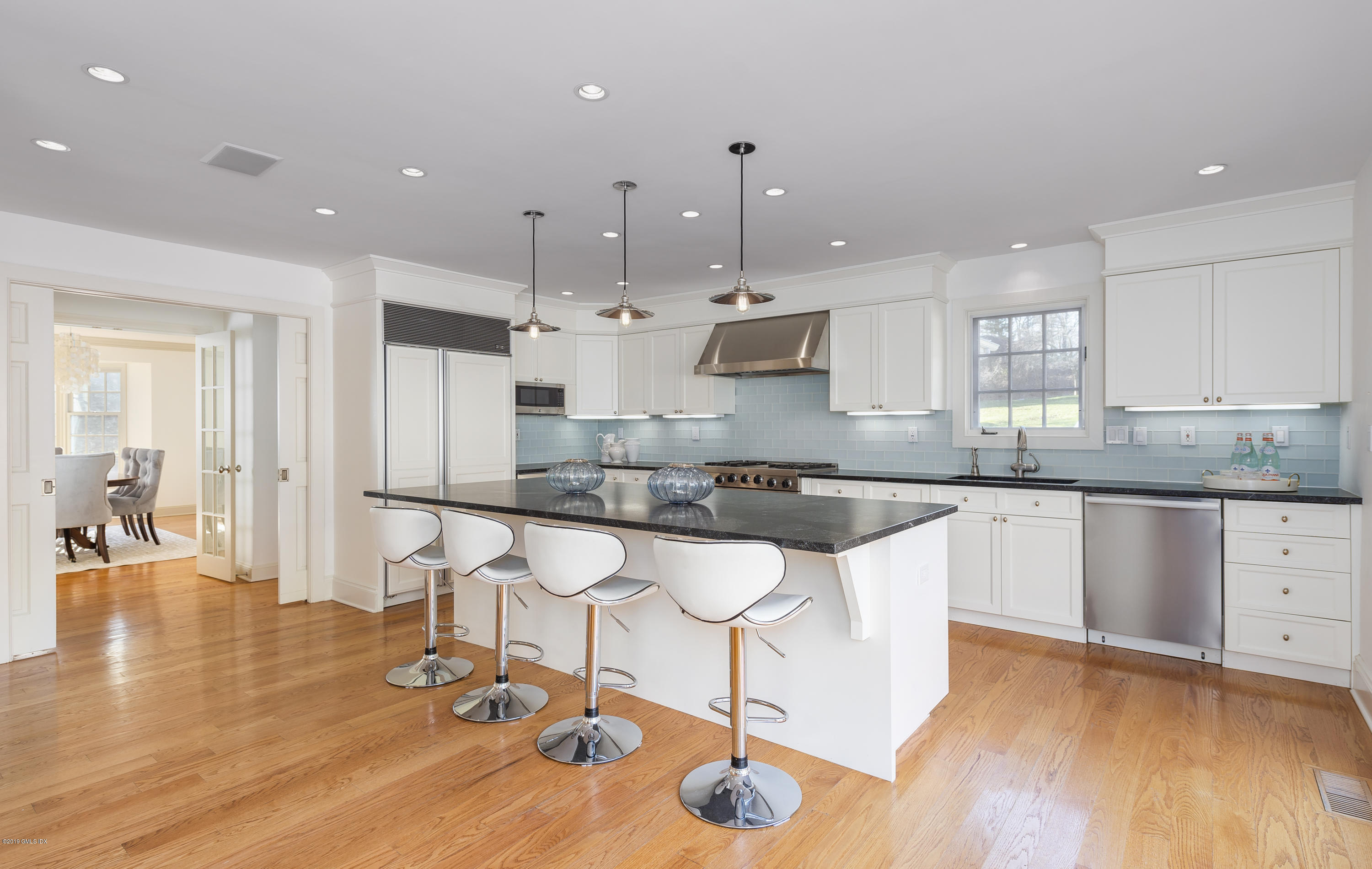 111 Dingletown Road Greenwich, CT 06830 - Photo 8 of 44 a large kitchen with lots of counter space wooden floor and appliances