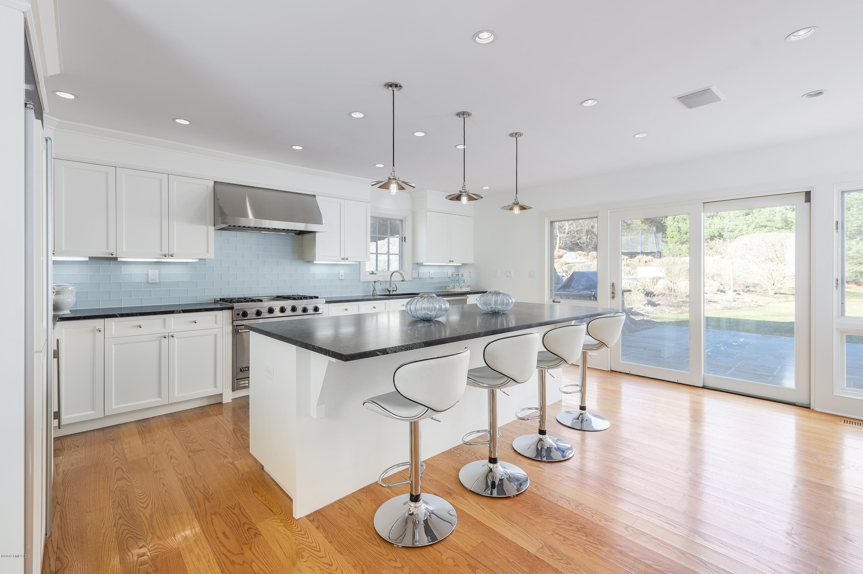 111 Dingletown Road Greenwich, CT 06830 - Photo 9 of 44 a kitchen with stainless steel appliances granite countertop a sink a stove a dining table and chairs