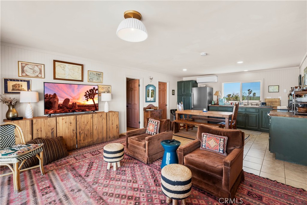 2750 Gibralter Road Landers, CA 92285 - Photo 12 of 56 a living room with furniture a rug and a painting on the wall