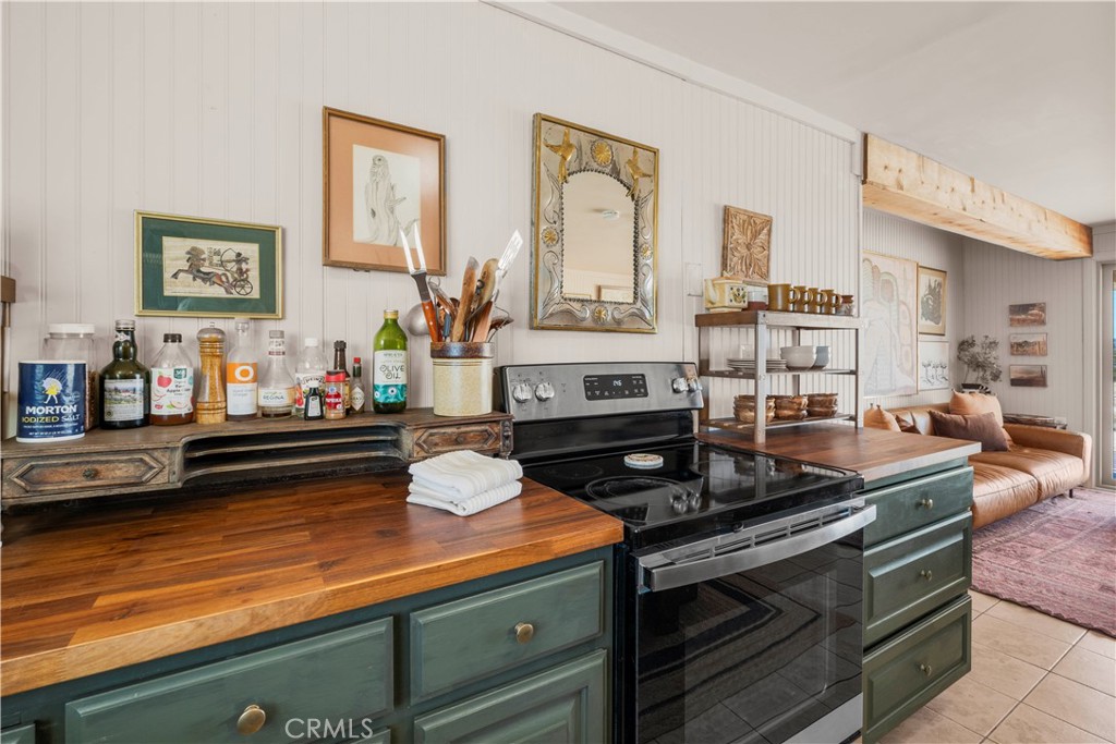 2750 Gibralter Road Landers, CA 92285 - Photo 17 of 56 a kitchen with stainless steel appliances a stove and cabinets
