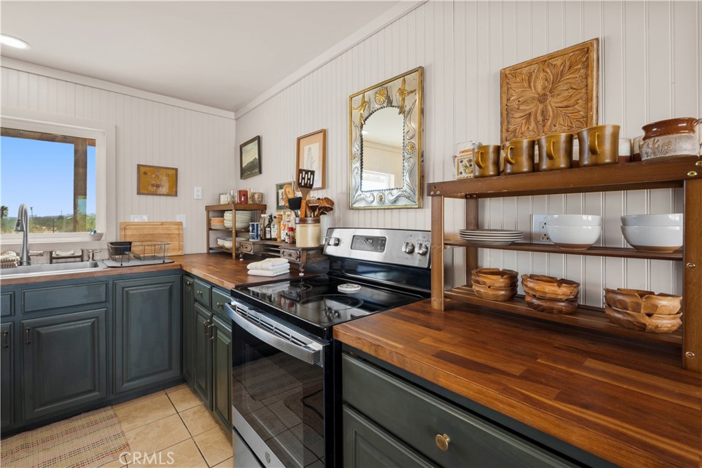 2750 Gibralter Road Landers, CA 92285 - Photo 18 of 56 a kitchen with a sink stove and cabinets