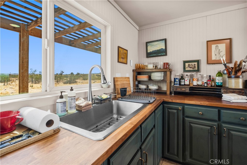 2750 Gibralter Road Landers, CA 92285 - Photo 21 of 56 a kitchen with stainless steel appliances granite countertop a sink stove and cabinets