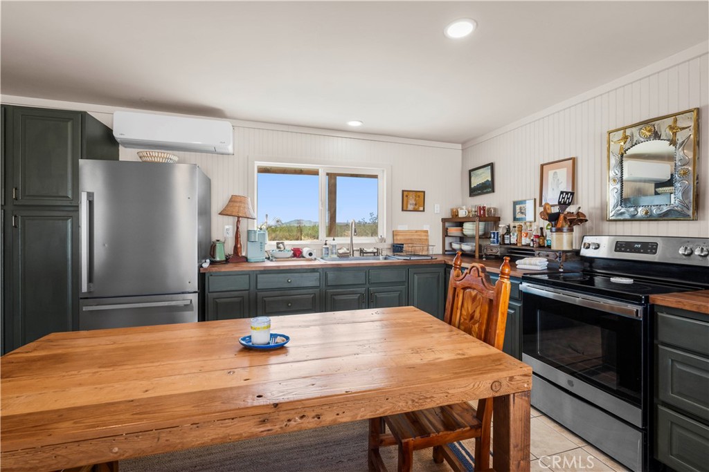2750 Gibralter Road Landers, CA 92285 - Photo 22 of 56 a kitchen with stainless steel appliances wooden floor and refrigerator