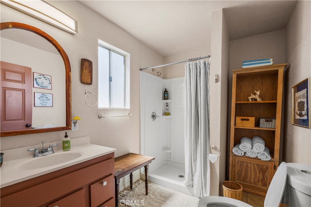 2750 Gibralter Road Landers, CA 92285 - Photo 26 of 56 a bathroom with a sink a mirror and a shower