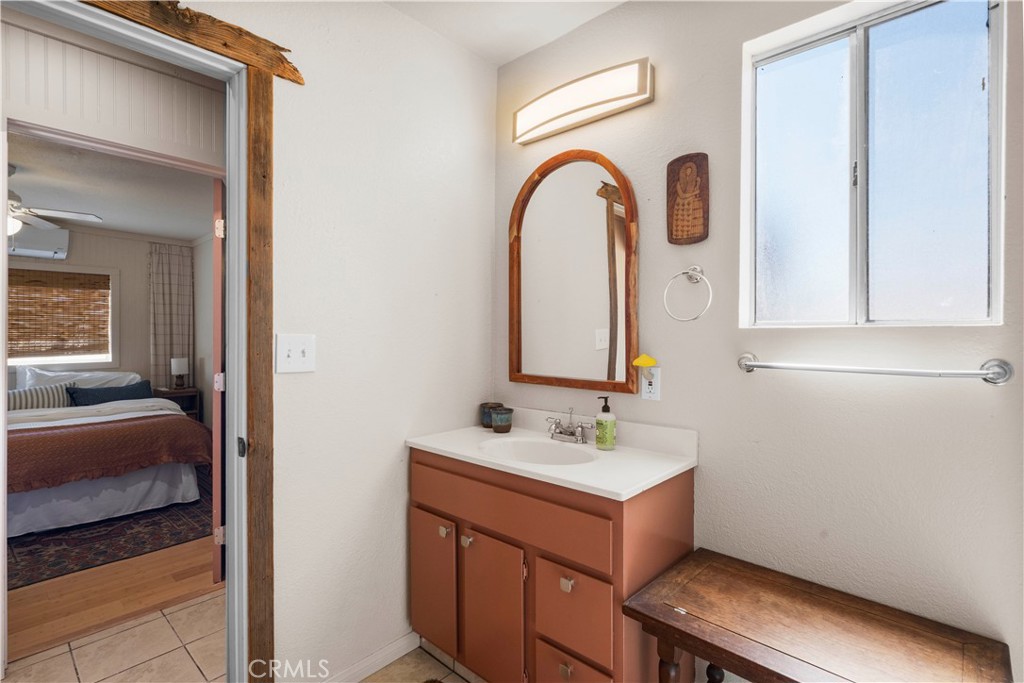 2750 Gibralter Road Landers, CA 92285 - Photo 27 of 56 a en suite bathroom with a sink and a mirror