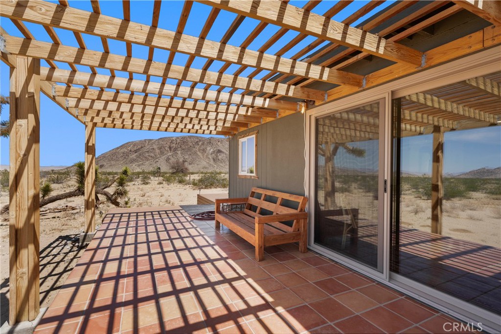 2750 Gibralter Road Landers, CA 92285 - Photo 39 of 56 a backyard of a house with barbeque oven table and chairs