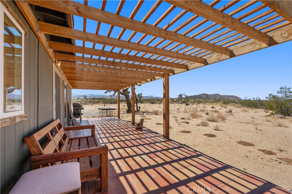2750 Gibralter Road Landers, CA 92285 - Photo 40 of 56 a view of a balcony with a table and chairs