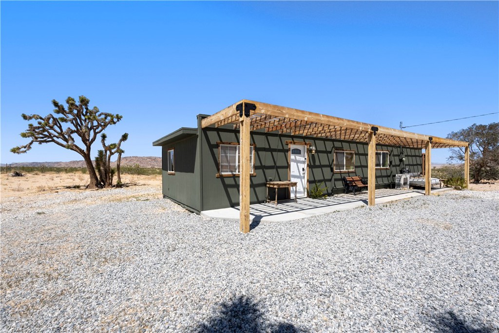 2750 Gibralter Road Landers, CA 92285 - Photo 43 of 56 a view of a house with backyard and a tree