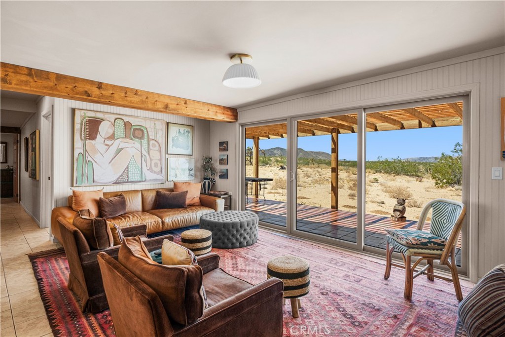 2750 Gibralter Road Landers, CA 92285 - Photo 7 of 56 a living room with furniture and a floor to ceiling window