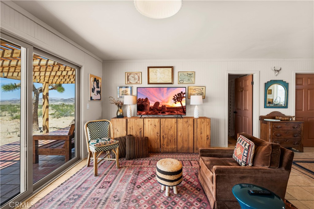 2750 Gibralter Road Landers, CA 92285 - Photo 10 of 56 a living room with furniture a rug and a large window