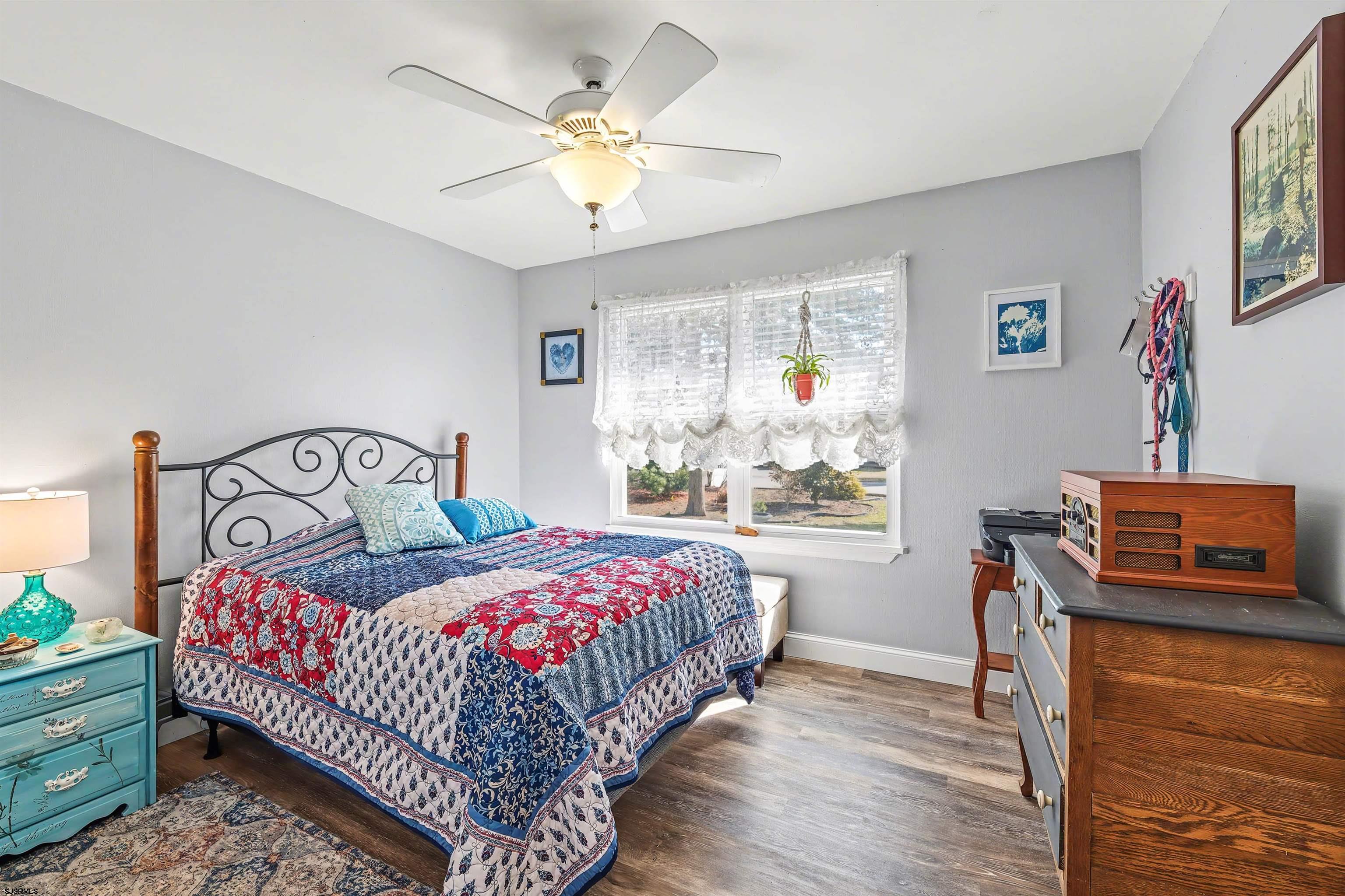 655 Weilers Lane Absecon, NJ 08201 - Photo 16 of 31 a bedroom with a bed a chandelier and a window