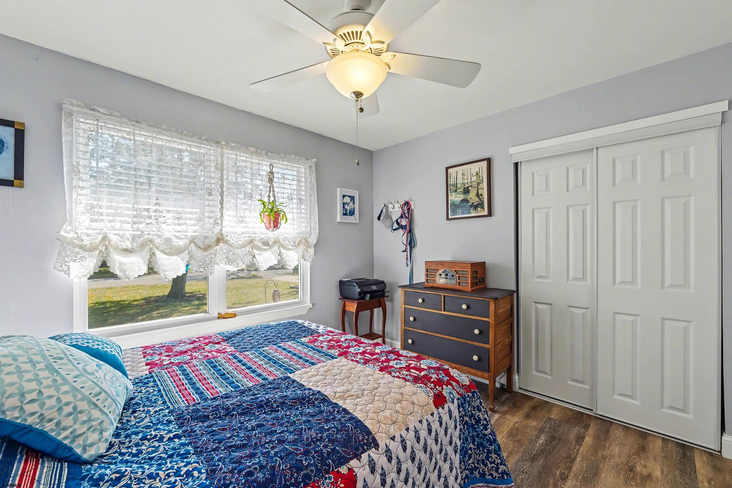 655 Weilers Lane Absecon, NJ 08201 - Photo 17 of 31 a bedroom with a bed and a chandelier
