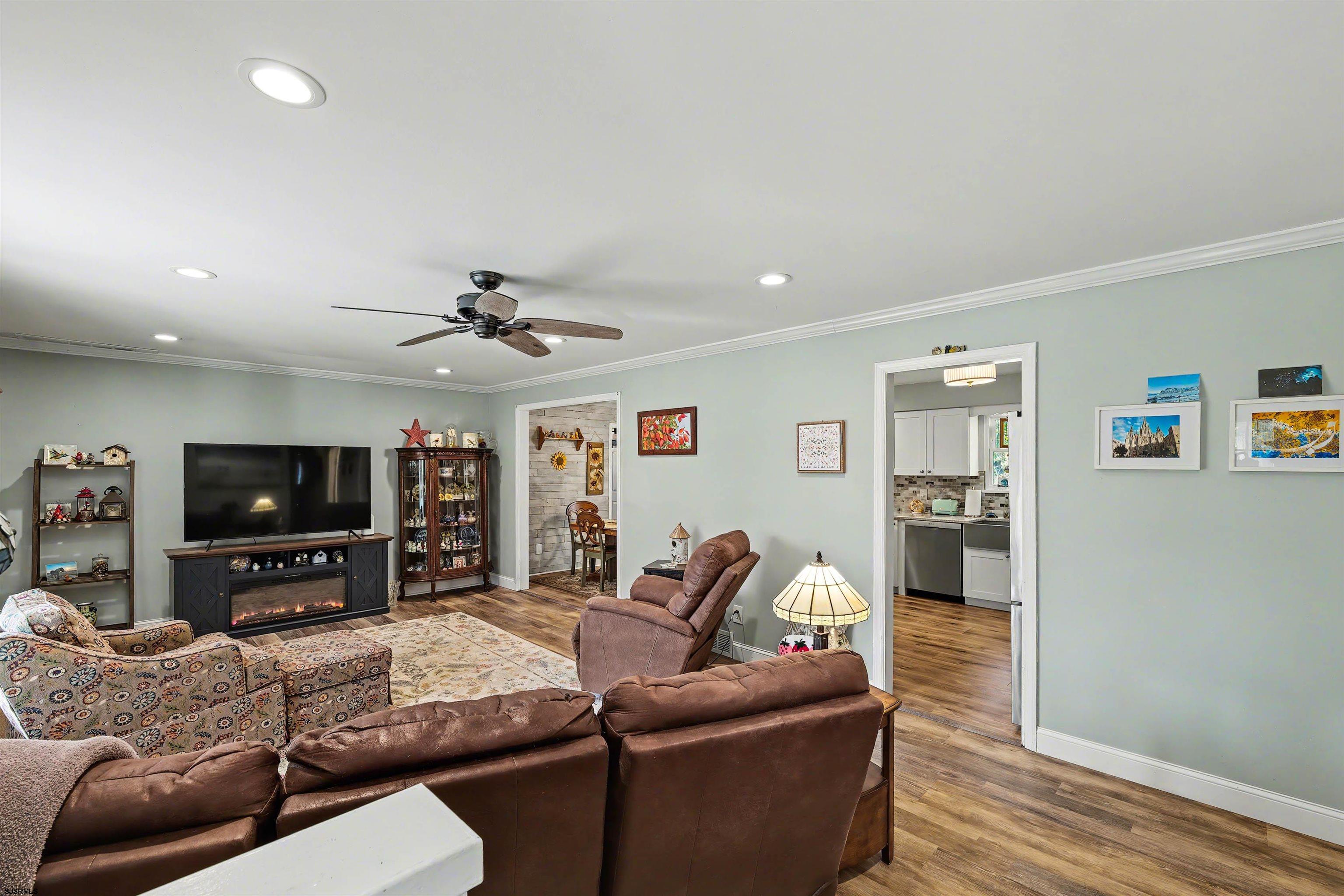 655 Weilers Lane Absecon, NJ 08201 - Photo 2 of 31 a living room with furniture and a flat screen tv