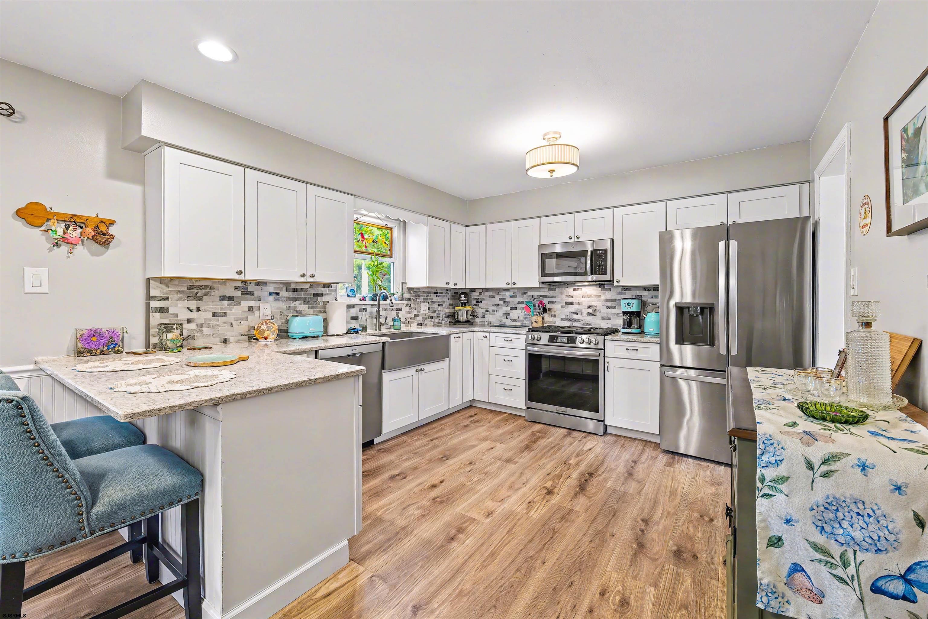 655 Weilers Lane Absecon, NJ 08201 - Photo 8 of 31 a kitchen with a sink stove a refrigerator and a microwave