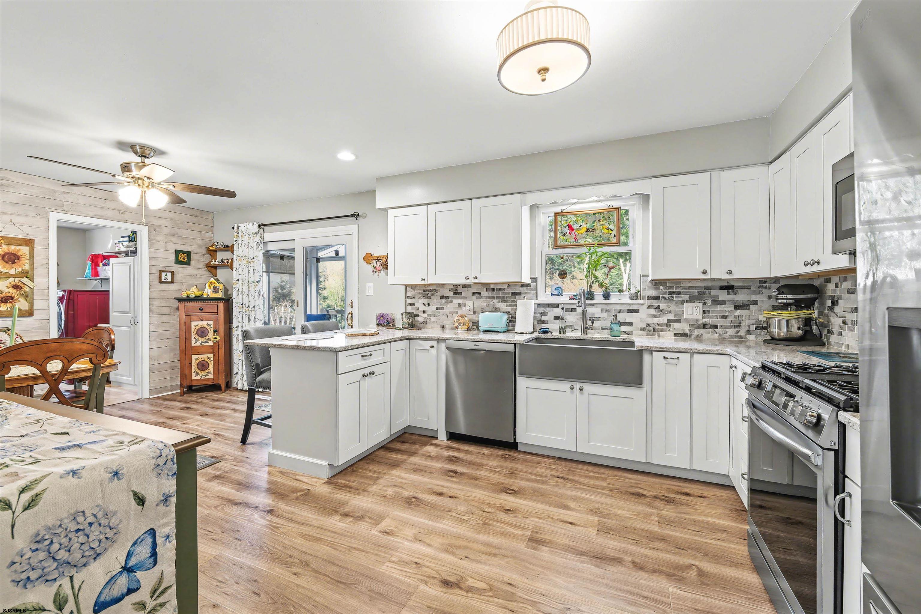 655 Weilers Lane Absecon, NJ 08201 - Photo 9 of 31 a kitchen with a sink cabinets stainless steel appliances and a window
