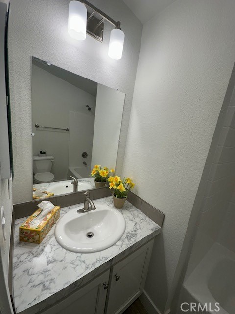 43601 East Florida Avenue, Unit 43 Hemet, CA 92544 - Photo 11 of 21 a bathroom with a granite countertop sink and a mirror
