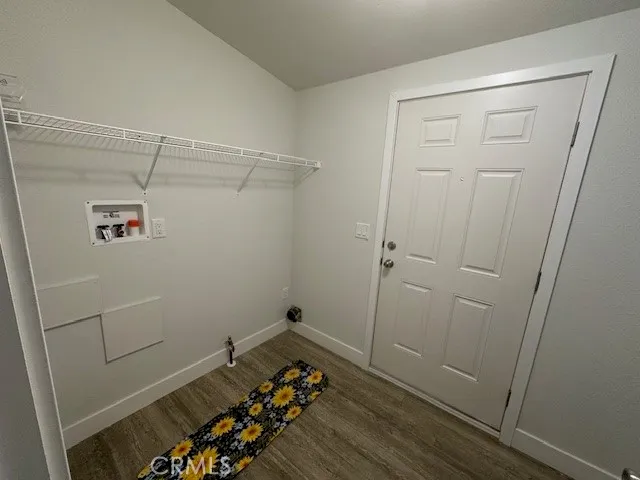 a view of a room with wooden floor