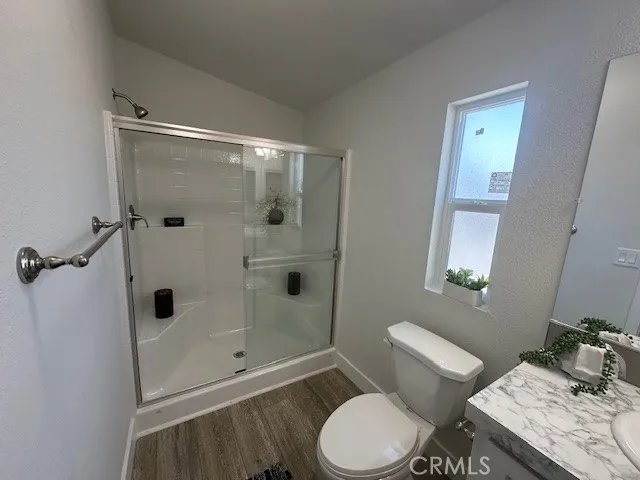 a bathroom with a toilet a sink and shower