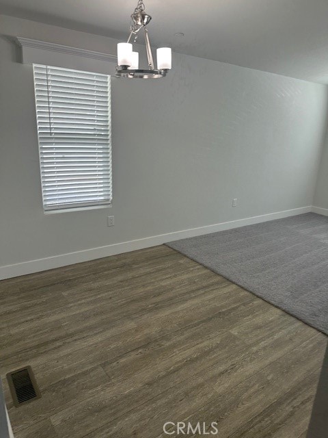 43601 East Florida Avenue, Unit 43 Hemet, CA 92544 - Photo 17 of 21 an empty room with wooden floor chandelier and windows