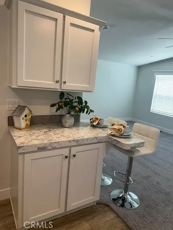 a bathroom with a granite countertop sink a toilet and a mirror
