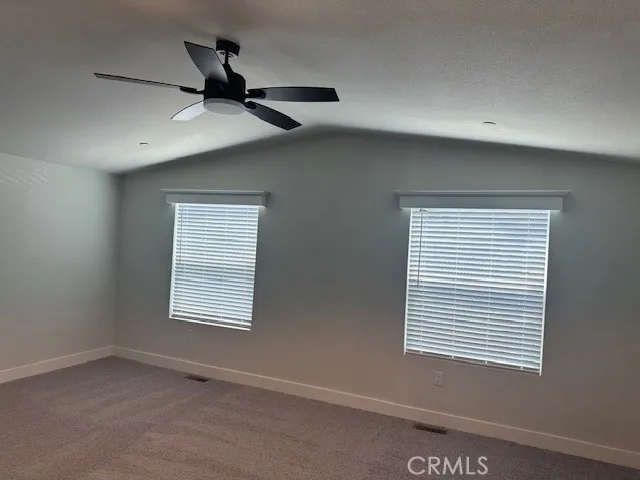 a view of a livingroom with a ceiling fan and window