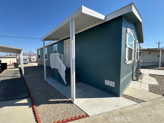43601 East Florida Avenue, Unit 43 Hemet, CA 92544 - Photo 3 of 21 a view of a porch with a table and chairs