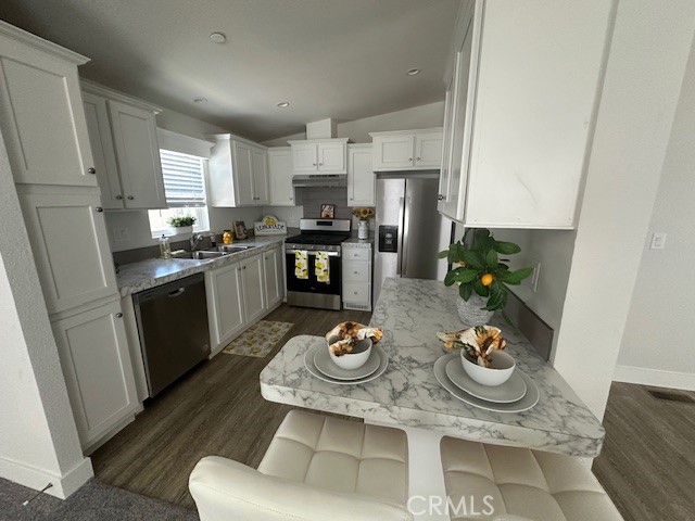 43601 East Florida Avenue, Unit 43 Hemet, CA 92544 - Photo 6 of 21 a kitchen with stainless steel appliances granite countertop a refrigerator a stove a sink and white cabinets with wooden floor