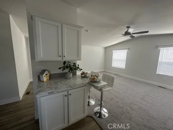 a bathroom with a granite countertop sink a mirror and a shower
