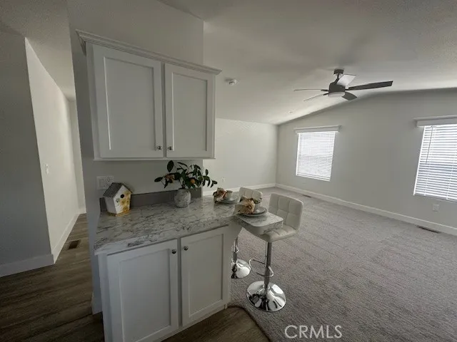 a bathroom with a granite countertop sink a mirror and a shower