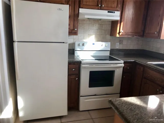 a white refrigerator freezer sitting inside of a kitchen