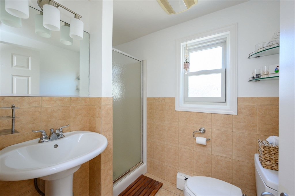 18 Standish Road Hull, MA 02045 - Photo 16 of 35 a bathroom with a sink a mirror and a toilet