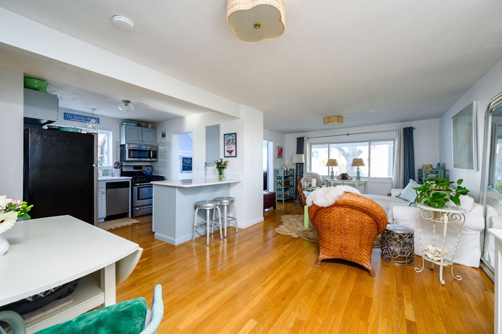 18 Standish Road Hull, MA 02045 - Photo 9 of 35 a living room with furniture and kitchen view