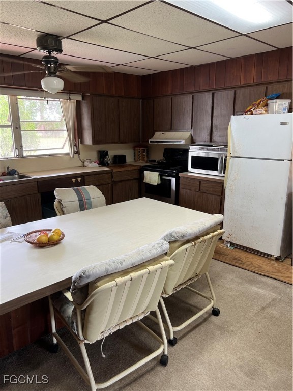 2111 Gardner Court Alva, FL 33920 - Photo 24 of 47 a kitchen with kitchen island a stove a table and chairs
