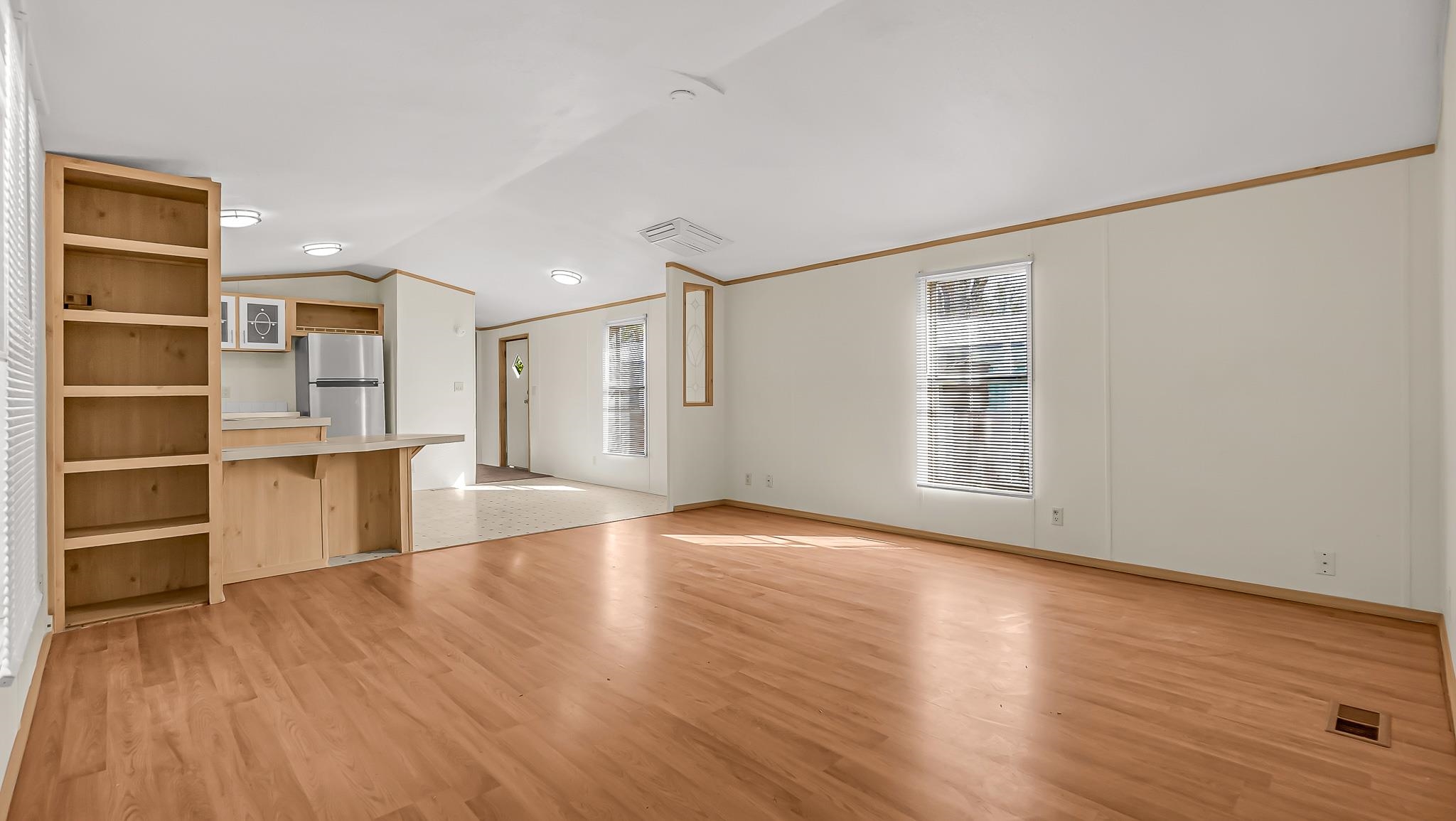 534 Normandy Way Grand Junction, CO 81501 - Photo 11 of 32 a view of empty room with wooden floor and windows