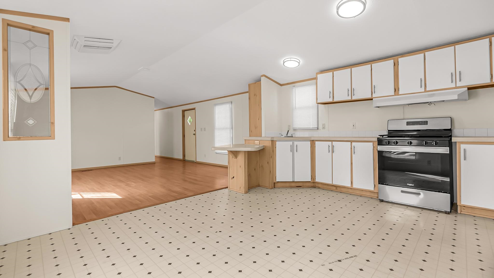 534 Normandy Way Grand Junction, CO 81501 - Photo 14 of 32 a kitchen with a refrigerator and white cabinets